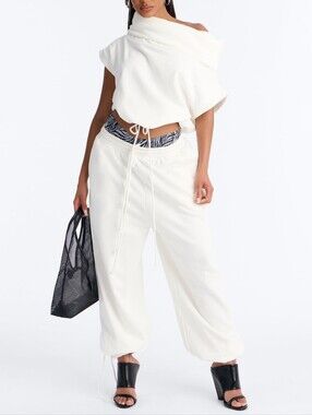 The White Women's Set Consists of Two Elements: Top And Loose Jogger